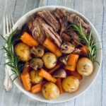 Bowl of pot roast with vegetables and rosemary