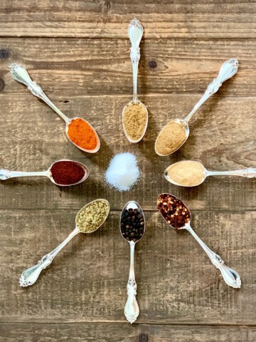 Potlatch Seasoning Ingredients on spoons on wooden board