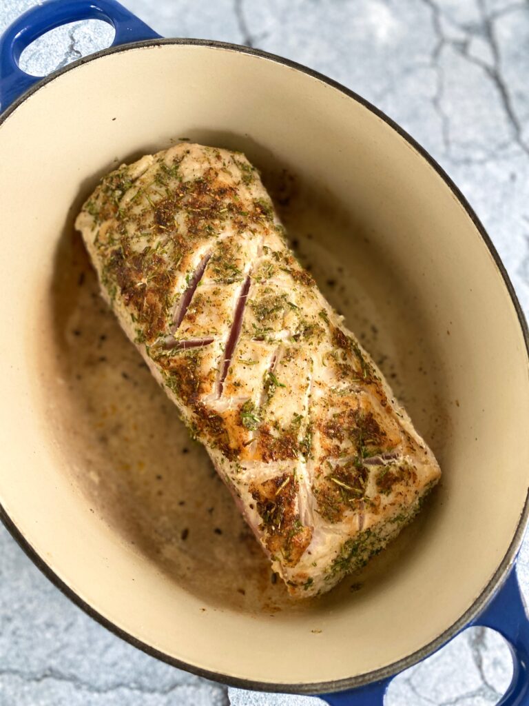 seared meat in blue dutch oven