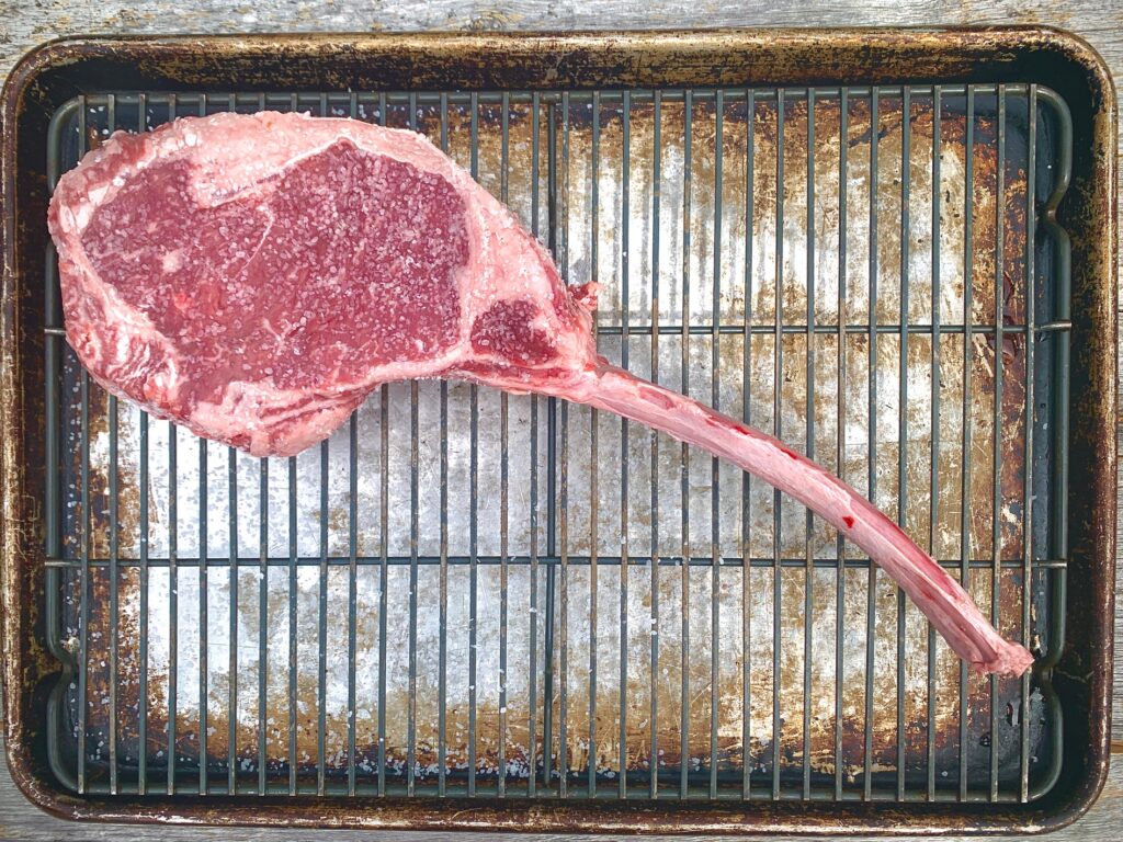 salting a steak on baking rack