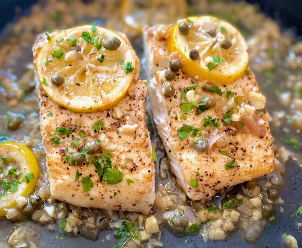 Seared halibut close up with lemons