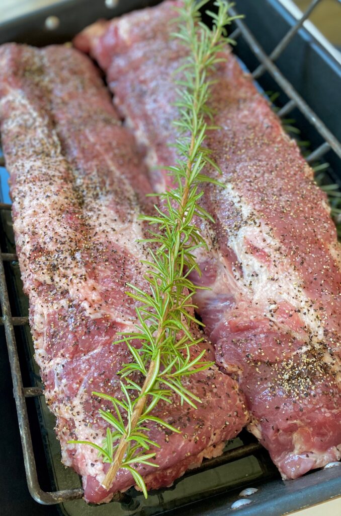 seasoned ribs with rosemary sprig
