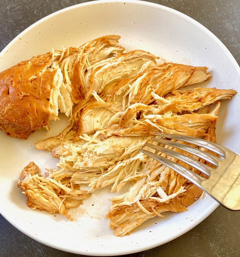 shredding chicken with fork