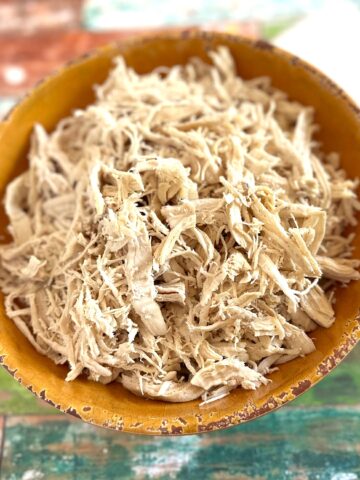 shredded chicken in a yellow bowl