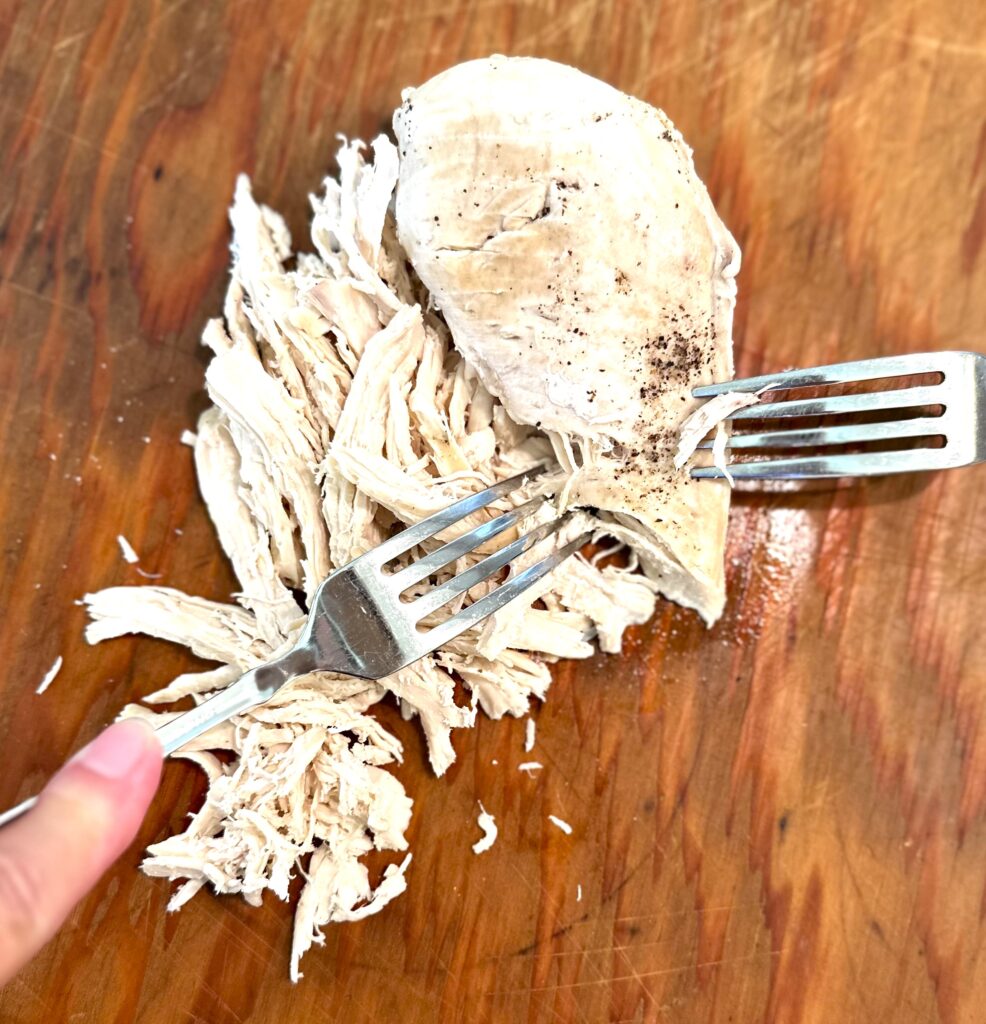 Shredding chicken with forks