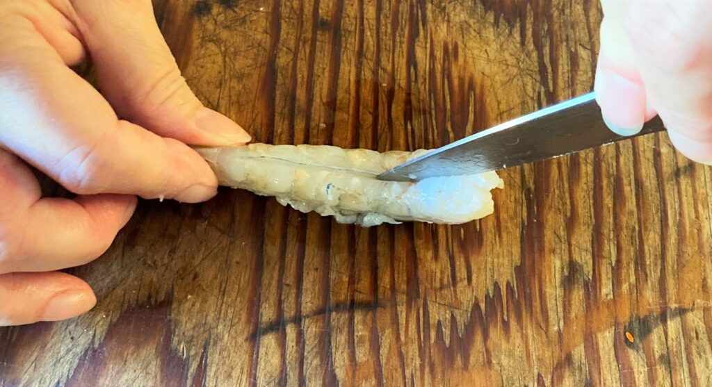 Make incision through prawn