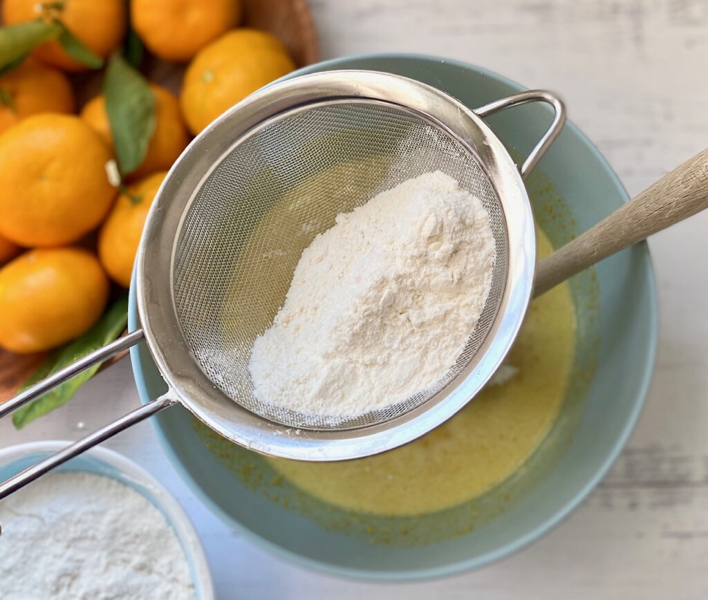 Sifting flour into a cake mix