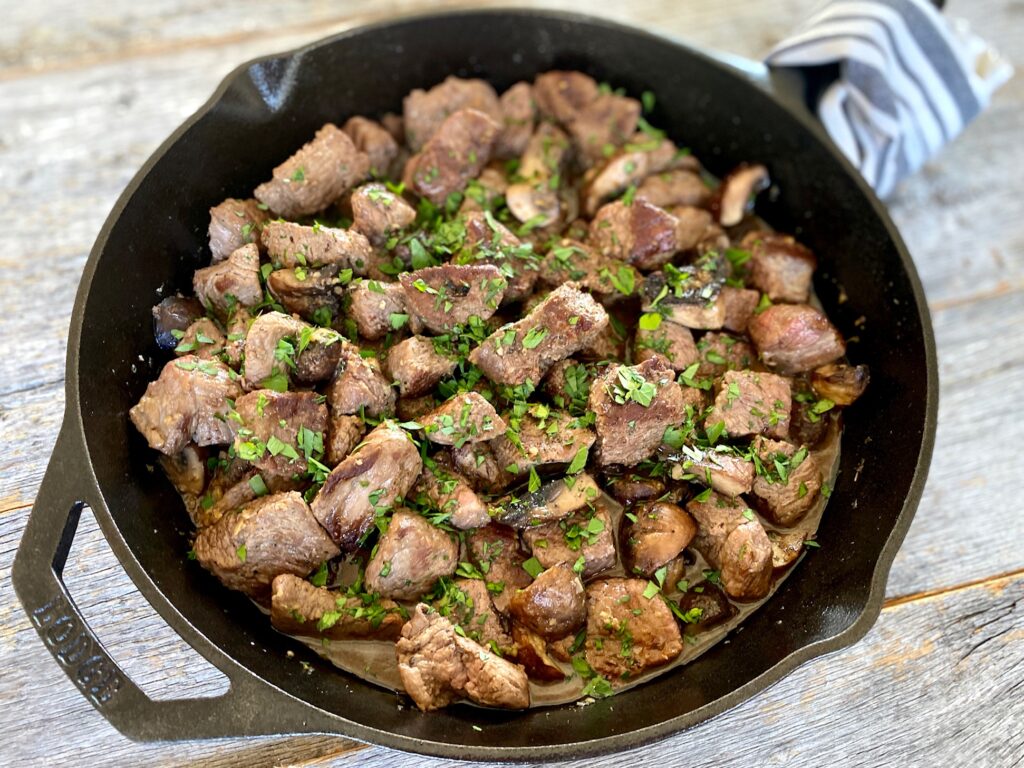Steak bits in cast iron pan