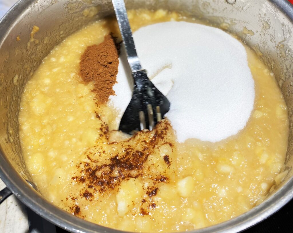 Adding sugar, cinnamon and clove