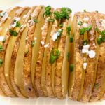 close up of a Hasselback Potato with chives