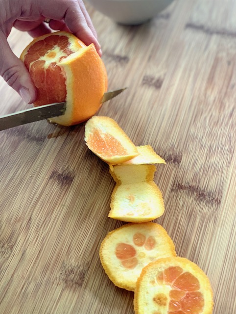 Cutting peel off oranges for a supreme