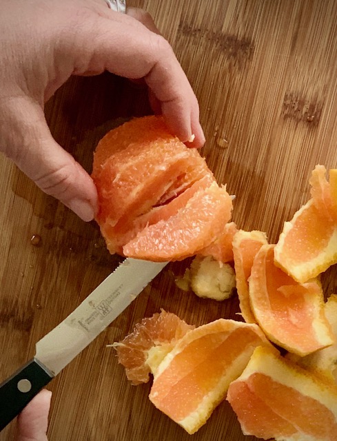 Carefully slice the segments of oranges