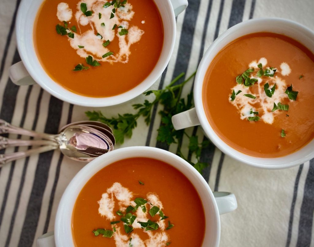 3 bowls Roasted Tomato Soup with garnishes