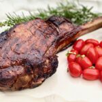 one ribeye steak with french bone on a platter