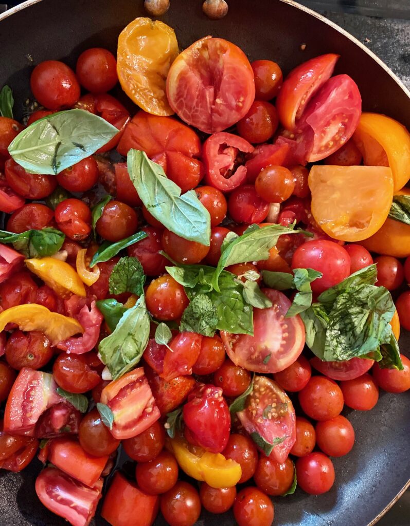 tomatoes, basil, garlic in pan