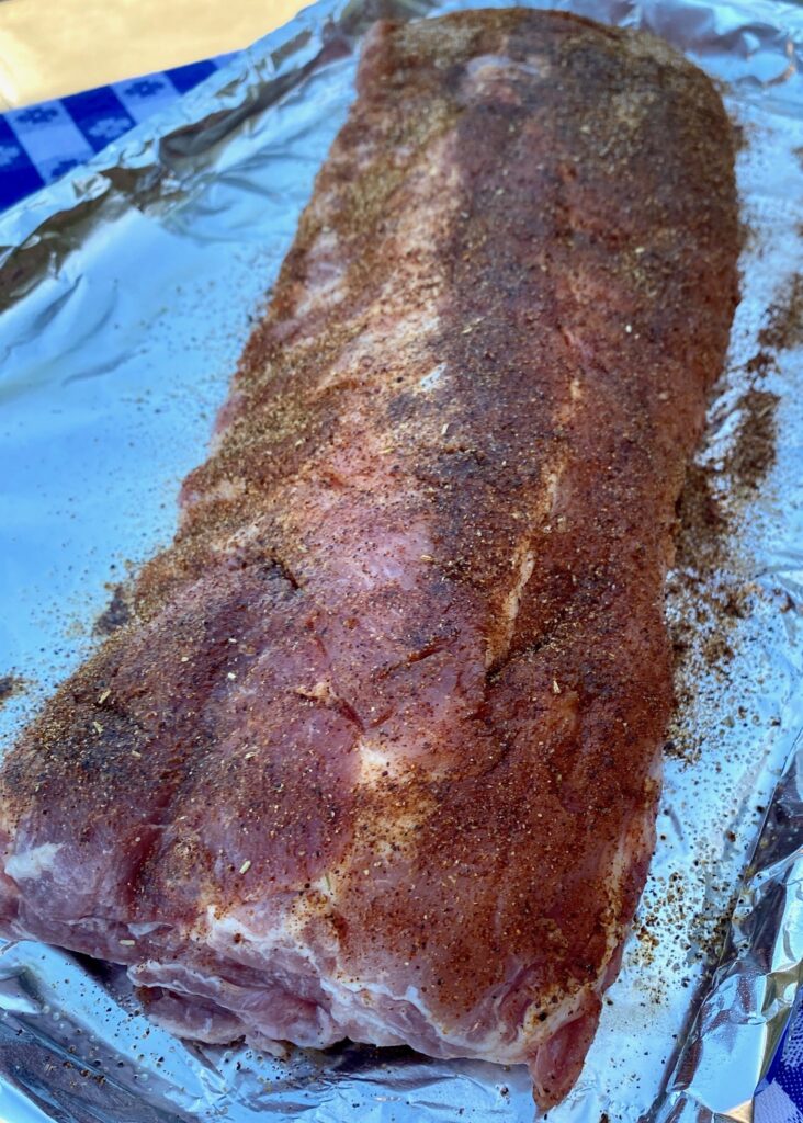 Unbaked baby back ribs with rub