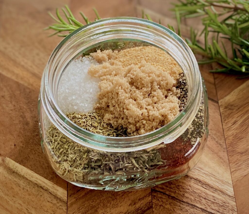 a glass jar with unmixed spices.