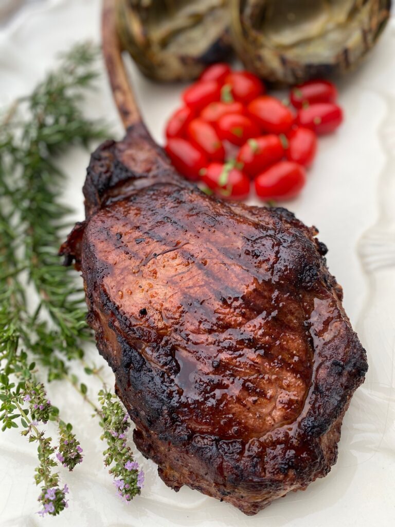 platter with steak, tomatoes and rosemary