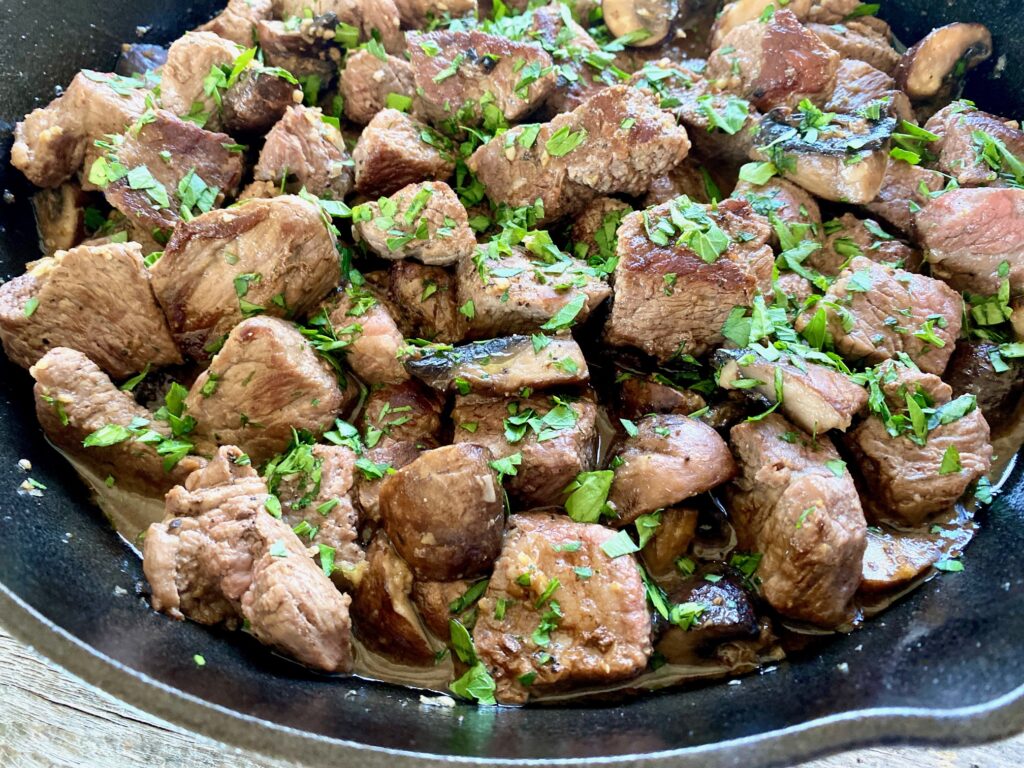 very close up steak bites in a pan