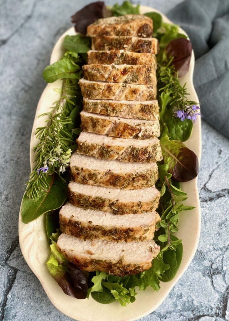 sliced roast on platter with greens