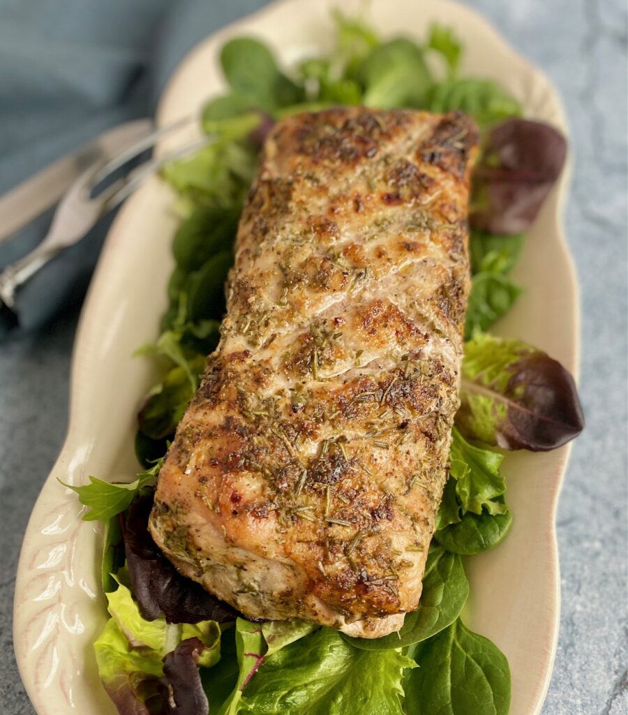 whole pork roast uncut with salad greens