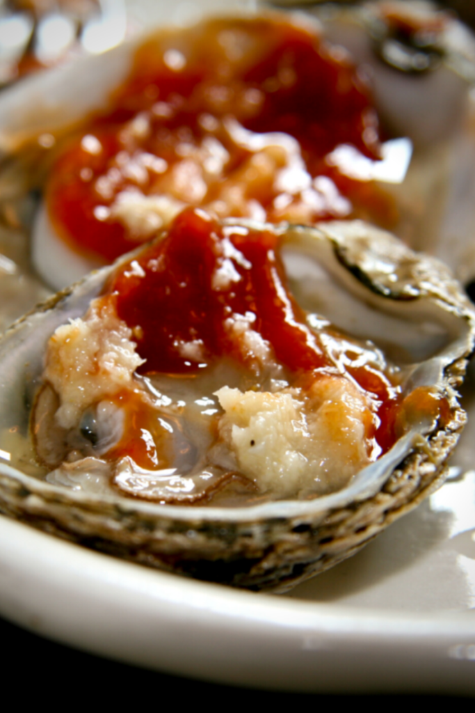 oyster on half shell with a sauce